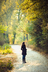 Fototapeta premium girl walks in beautiful autumn park