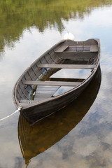 Rural wooden rowboat partly filled with water