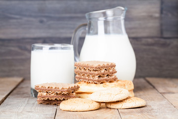 Milk and cookies on wooden background, dessert