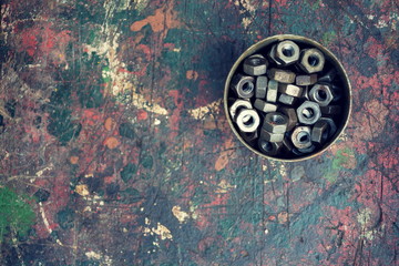 Filtered nuts in tin can on colorful wooden background