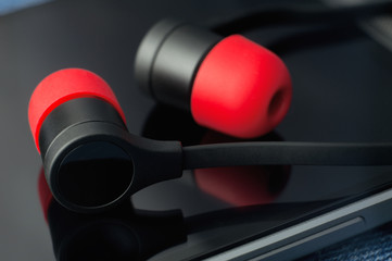 black and red headphones on a glass surface