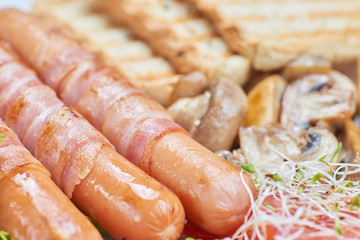 Fried sausages wrapped in bacon