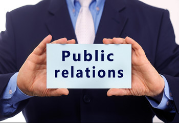 Business man hold paper public relations text on it
