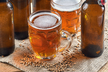 Wheat beer in old mugs on wooden table
