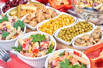 Chicken and vegetable salad in white bowls. Salad ingredients