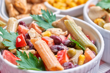 Chicken and vegetable salad in white bowls. Salad ingredients