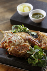 Fried beef and chicken leg on the table in restaurant