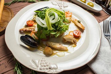 Various Seafood Salad on wooden table