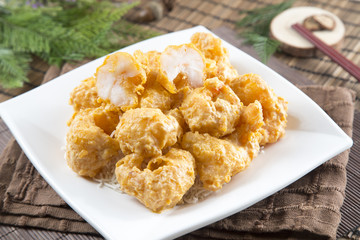 Traditional chinese plate of fried breaded squids on the table in restaurant