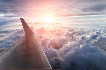 Wing of the plane on blue sky