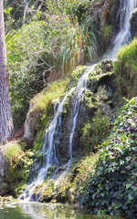 Fototapeta na wymiar Waterfall in the meditation Garden in Santa Monica, United States. Park of five religions at the lake Shrine, landscape. 