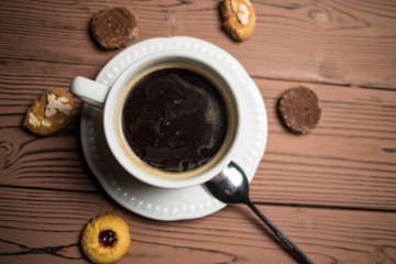 coffee americano with  beans on wooden table