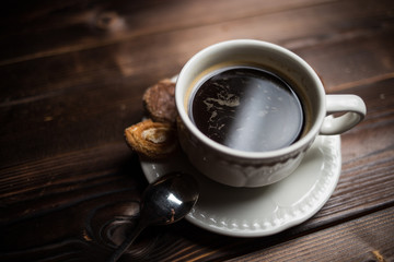 coffee americano with  beans on wooden table