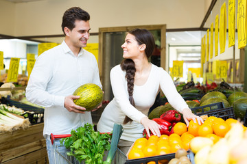 Obraz premium Young spouses choosing fruits