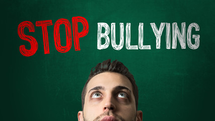 Guy Looking Up in a Chalkboard with the text: Stop Bullying