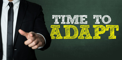 Business man pointing with the text: Time to Adapt