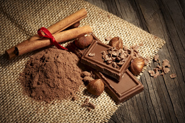 Chocolate with nuts on the wooden background