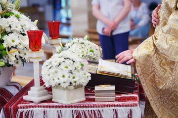 Church supplies for baptism on the table. Ceremony of a christen