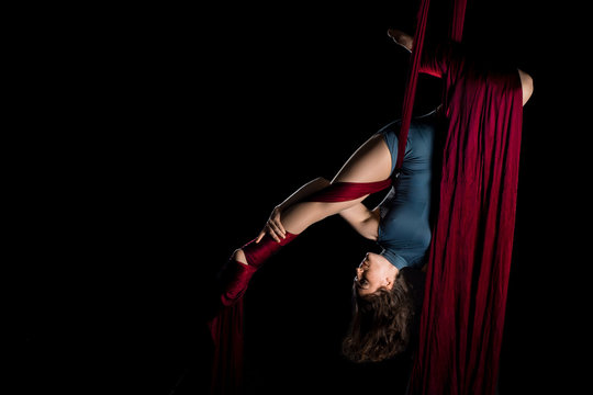 Aerial dancer woman isolated on black