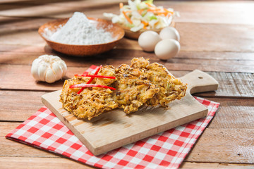 Fried breaded vegetables on the cutting board  in restaurant