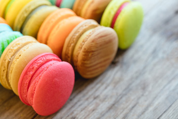 Tasty french macarons on a wooden table with vintage color tone