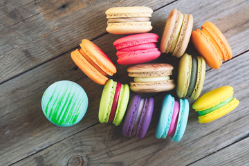 Tasty french macarons on a wooden table with vintage color tone