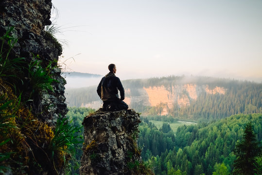 Man Sitting On The Top Of The Mountain In Yoga Pose