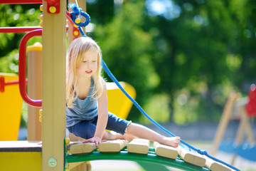 Cute little girl having fun on a playground © MNStudio