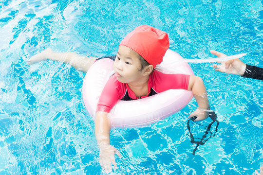 Pretty little asian girl in swimming pool
