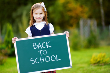 Cute little schoolgirl feeling excited about going back to school