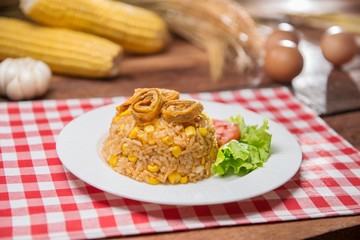 Plate of fried rice with herbs on the table in restaurant