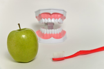 toothbrush and green apple, dental care concept
