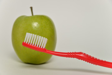 toothbrush and green apple, dental care concept