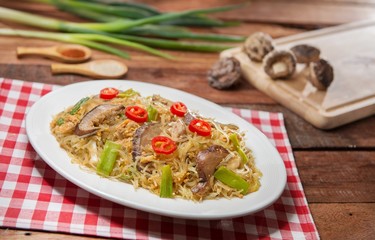 Plate of fried vermicelli with mushroom on the table in restaurant