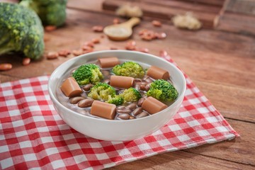 Bowl of soup with peanut, cauliflower and sausage on the table in restaurant