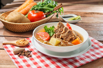 Bowl soup of pork and vegetables on the table in restaurant