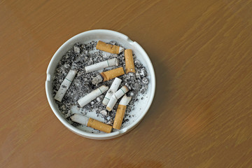 smoked cigarettes in white ashtray
