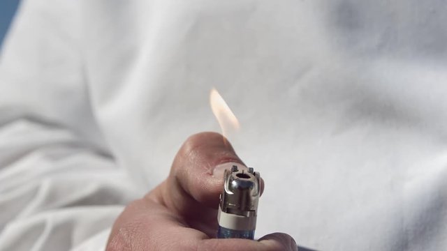 Hand holding lighter ignites the gas by rotating the flint mechanism and creating sparks.  All captured in slow motion @ 1500 frames per second.

