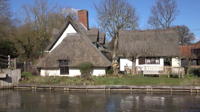 Flatford England historic 17th centrury mill on river. Flatford Mill watermill built in 1733 on the River Stour, Suffolk, England. 17th century miller's cottage. Typically English rural landscape.