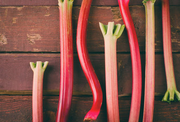 fresh organic red rhubarb on wooden table, Rustic style