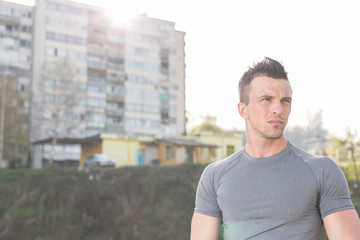 Fototapeta premium portrait of handsome jogging man while relaxing and take break a