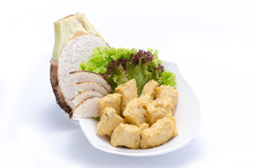 Fried yam cakes with herbs on white bowl