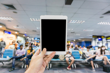 Woman using tablet at the airport - blurry background