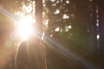 Young Woman raised hands outdoor with sunset mountains on backgr