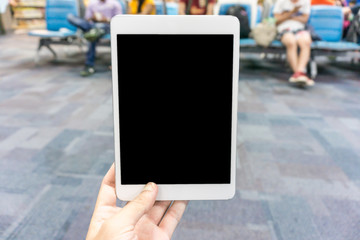 Woman using tablet at the airport - blurry background