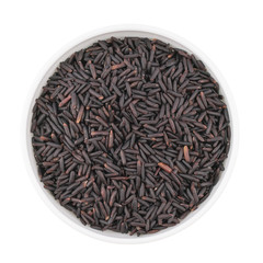 Bowl of black rice isolated on white background, top view