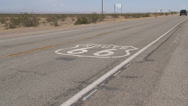 Car driving fast over the Route 66 sign
