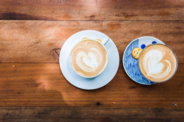 cup of cappucino and biscuits on a wood background
