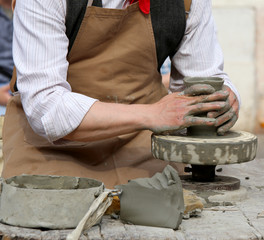 Potter with the hand lathe during production of a pot