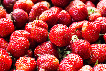 Fresh strawberry background. Ripe strawberry in close-up.